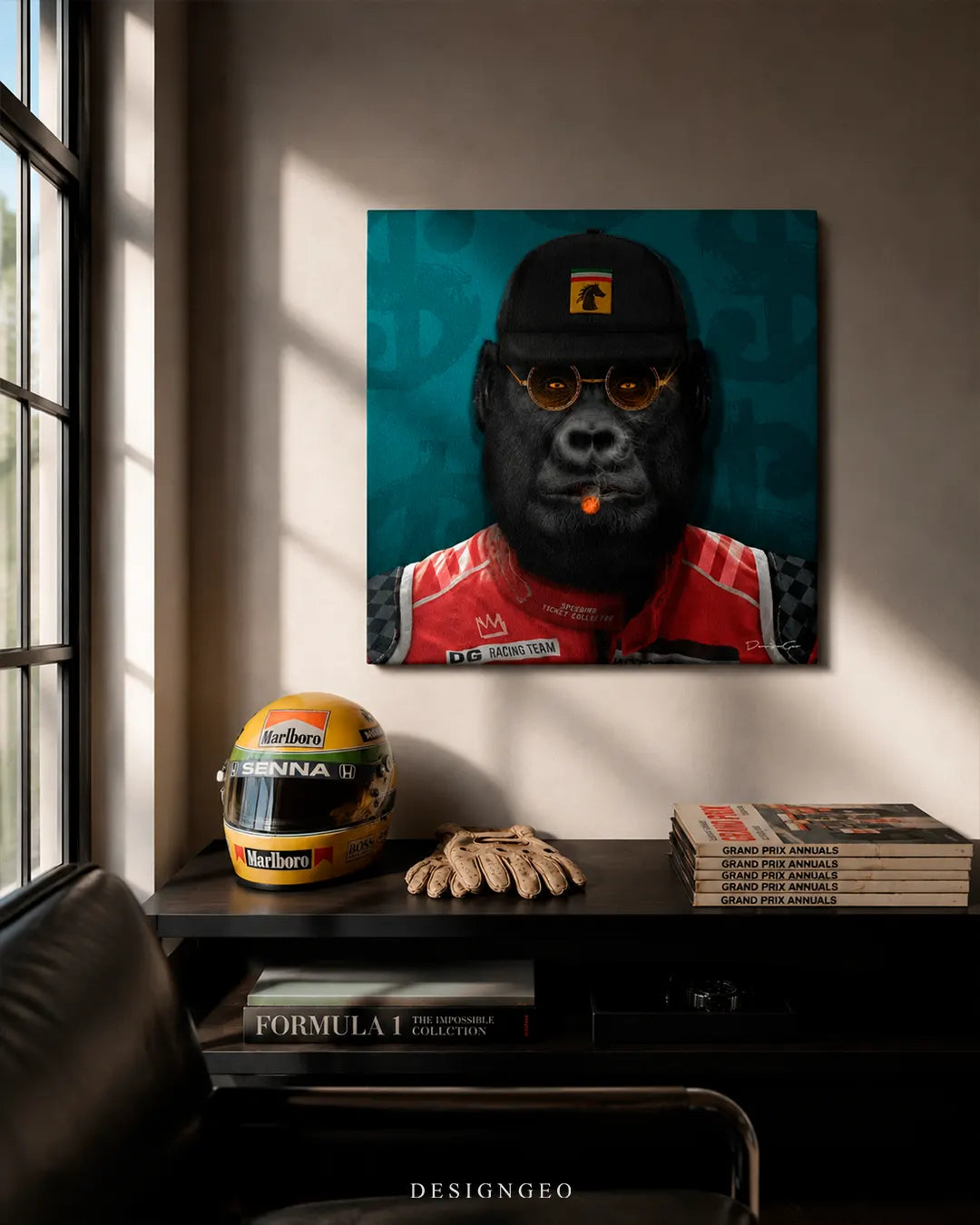 Square gorilla racing pilot canvas print mounted on a beige wall above a dark wooden console table with a replica Senna helmet, leather driving gloves, and Formula 1 books