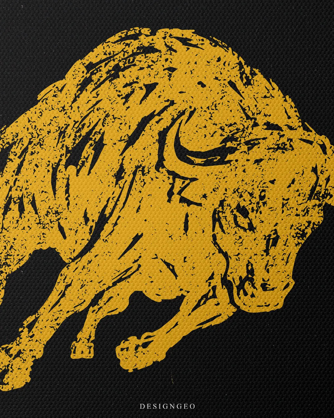 Close-up view of the canvas print detailing the textured head and horns of the yellow bull illustrated with black grain ink over a dark matte background