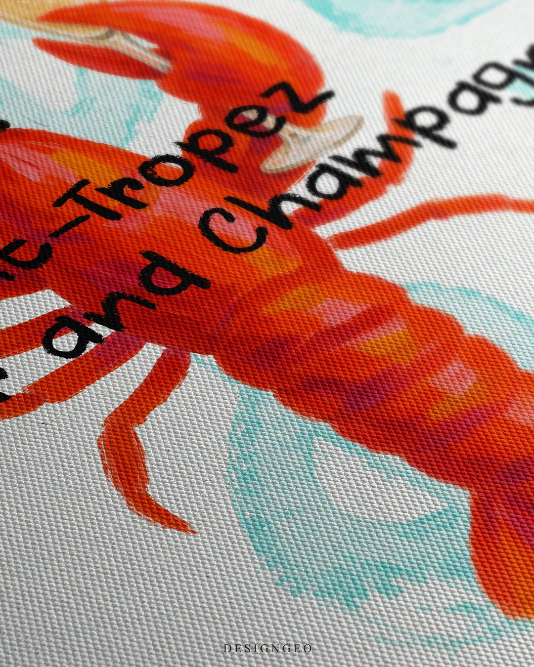 Angled macro view of the Saint-Tropez canvas print, showing brushstroke texture on the red lobster artwork and black painted typography on a woven canvas surface