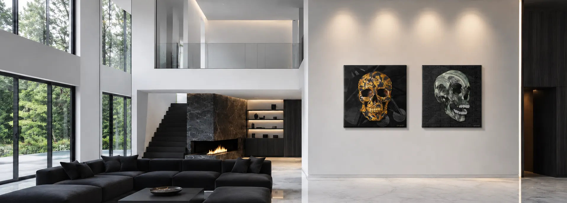 High-ceiling luxury mansion living room featuring a set of two square canvas prints showcasing a ornate gold floral skull and a US dollar bill skull, mounted side-by-side on a white wall above a black modern sectional sofa and marble fireplace