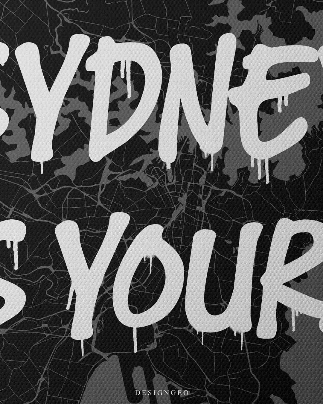 Close-up of minimalist city map art featuring Sydney's detailed urban grid and harbor coastline with the motivational phrase "Sydney is Yours" in crisp white graffiti typography on a dark background