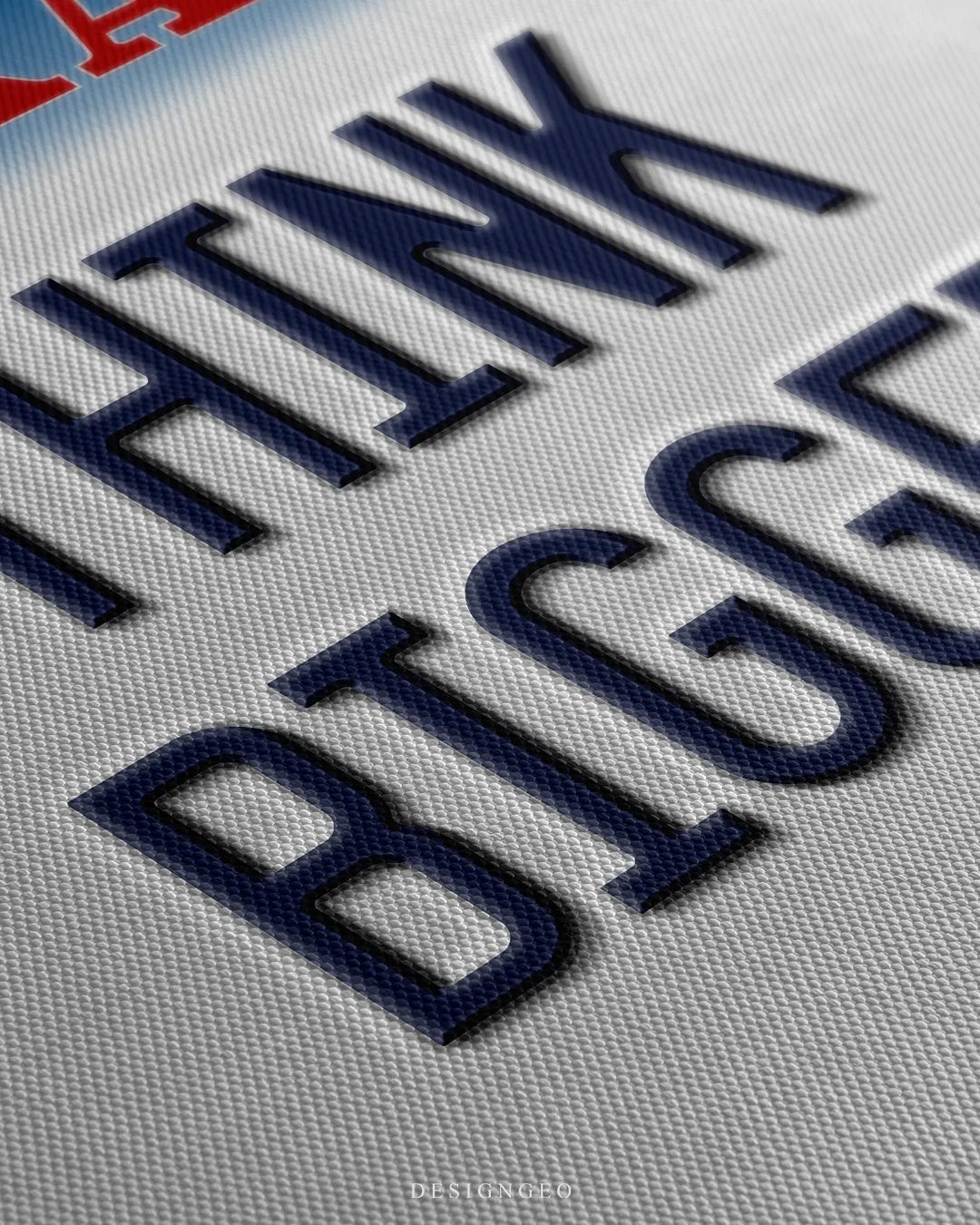 Angled close-up detail shot highlighting the 3D dark blue embossed THINK BIGGER letters, realistic drop shadow effect, and fine woven canvas fabric texture