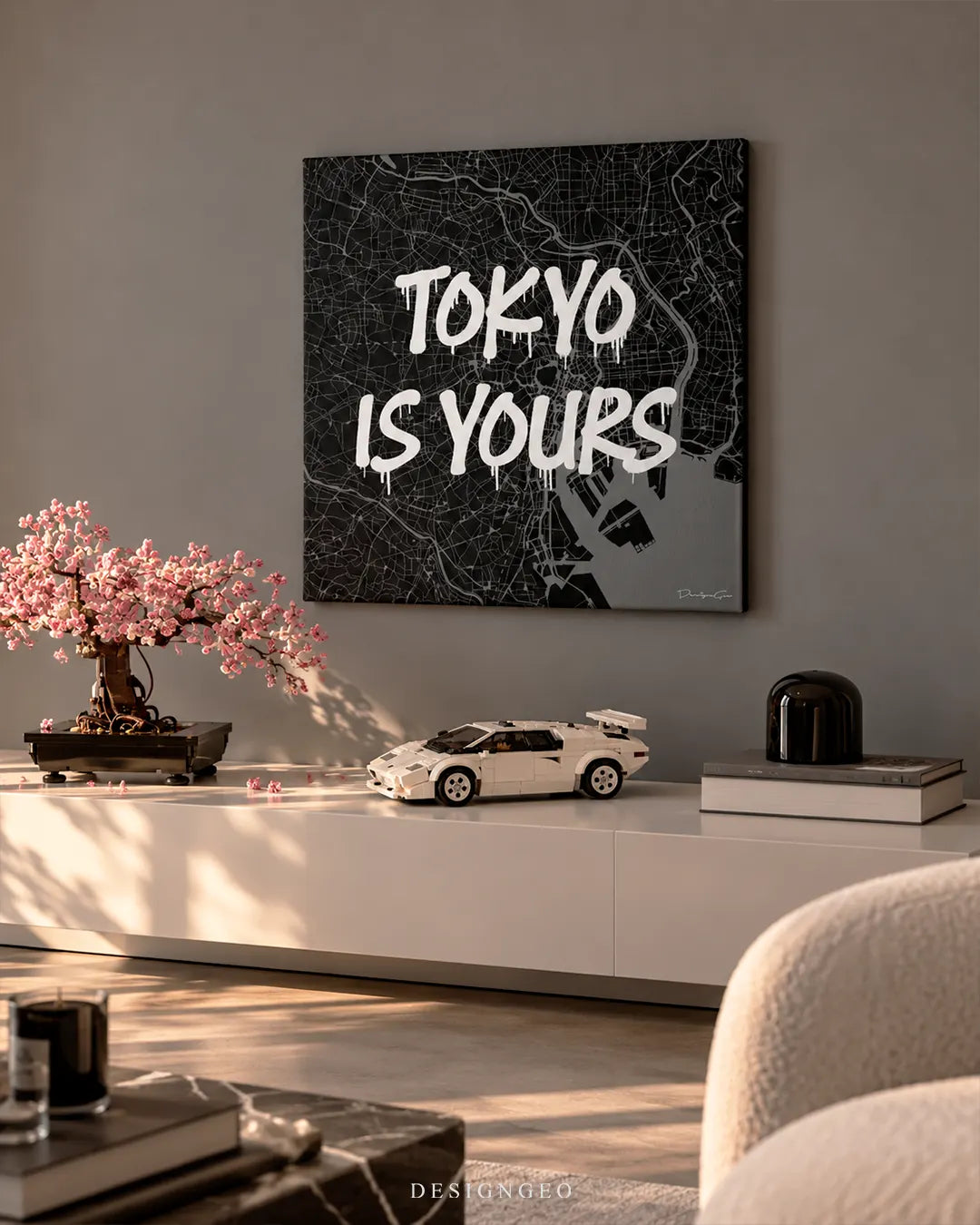 Tokyo Is Yours Tokyo map typography square canvas wall art mounted on gray wall above white console with cherry blossom bonsai and car model 0.75 inch thin wrap