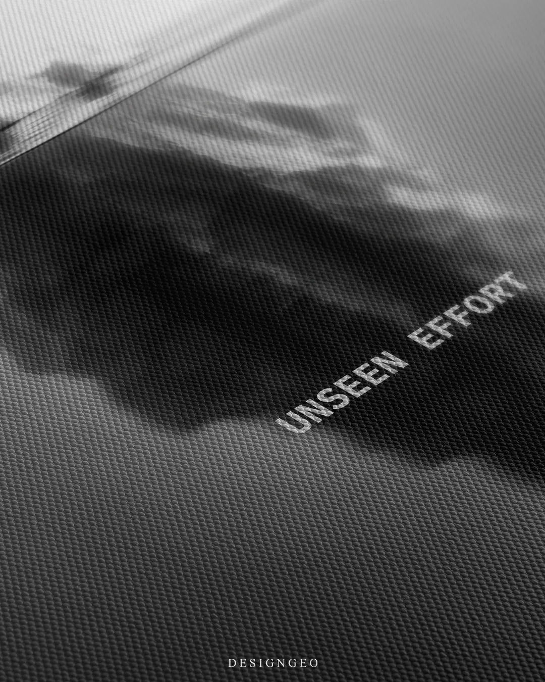 Angled detailed macro texture of fine woven canvas print showing iceberg submerged under water with Unseen Effort quote