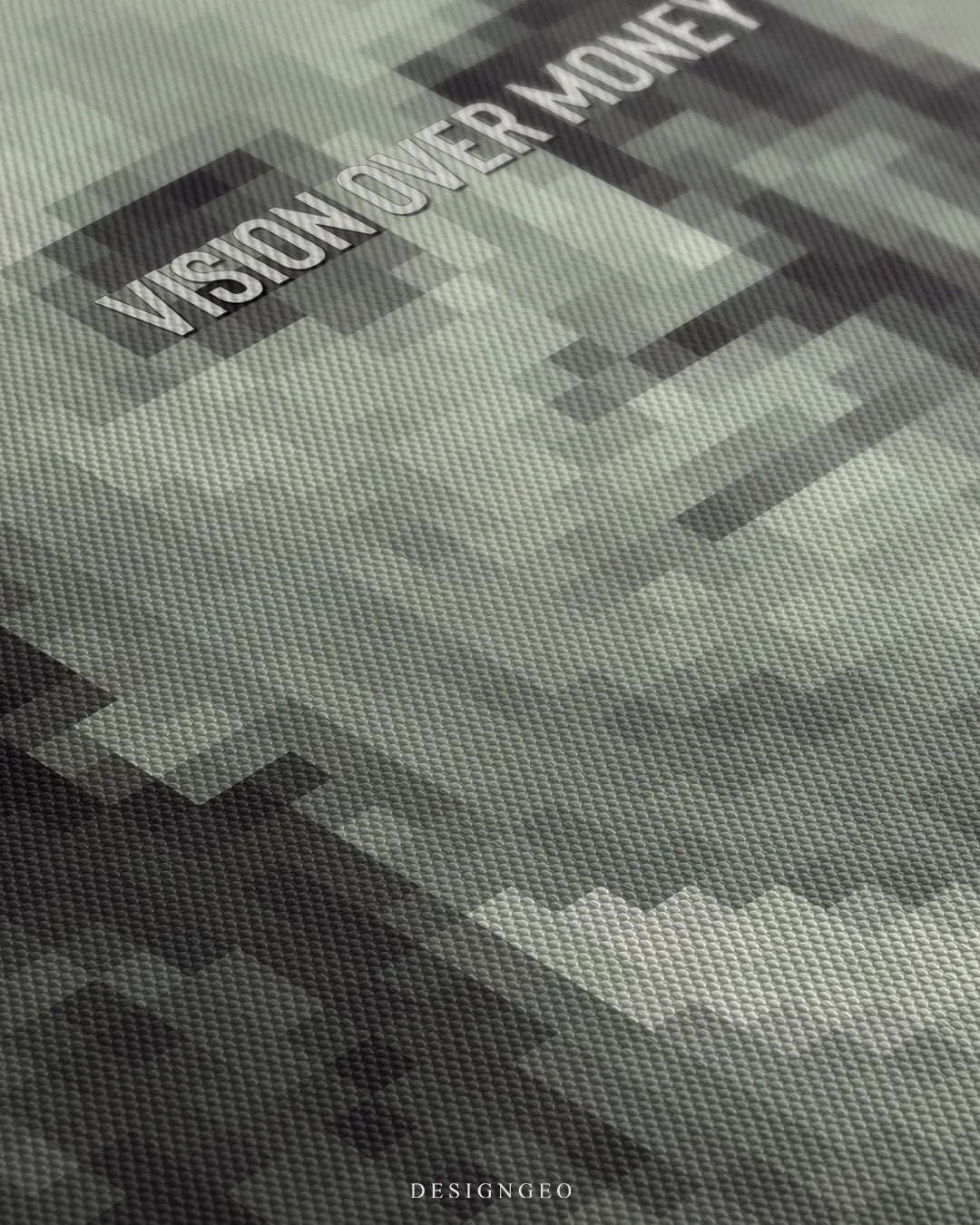 Angled macro view detailing fine woven canvas fabric texture, subtle pixelated mosaic patterns, and clean white lettering reading Vision Over Money