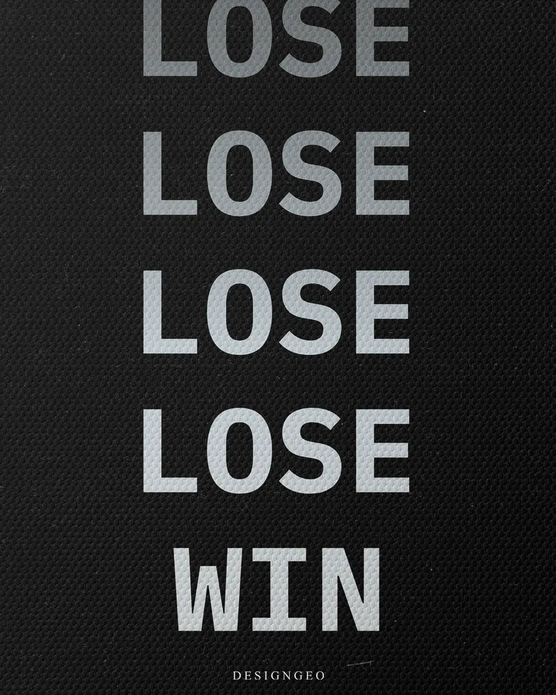 Close-up vertical shot showing the color gradient transition from dark gray LOSE text to bright white WIN text on fine black canvas fabric